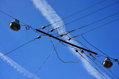 Low angle view of power lines against blue sky