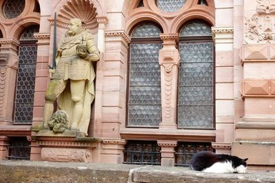 Statue against historic building