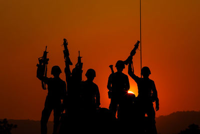 Silhouette people at sunset