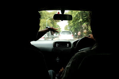 Rear view of man driving car