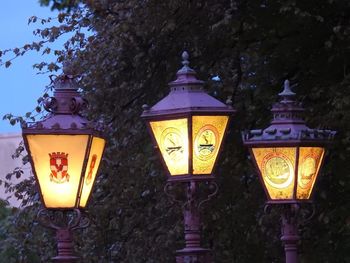 Low angle view of illuminated lanterns hanging in temple