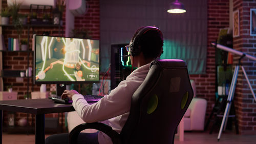 Side view of woman sitting in cafe