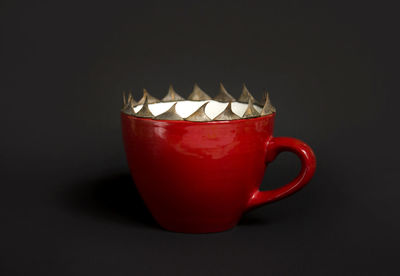 Close-up of drink served on table against black background