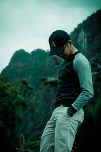 Side view of young man looking at mountain