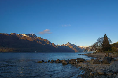 Scenic view of mountains against clear blue sky