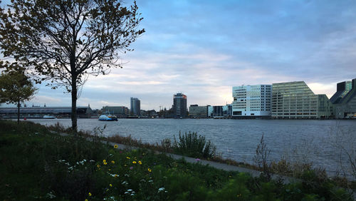 River and buildings against sky