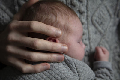 Close-up of baby hand in snow