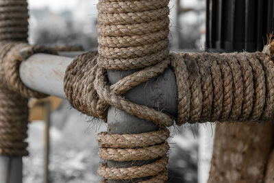 Close-up of rope tied on metal pole
