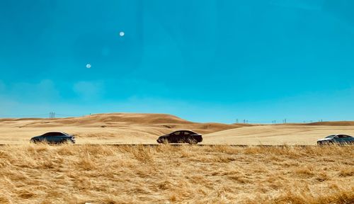 Hay bales on field against sky