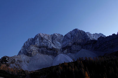 Scenic view of snowcapped mountains against clear blue sky