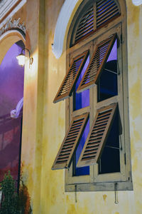Low angle view of illuminated building at dusk