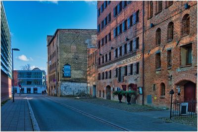 Street amidst buildings in city against sky