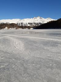 Scenic view of snowcapped mountains against clear sky during winter