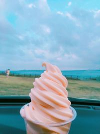 Close-up of hand holding ice cream cone