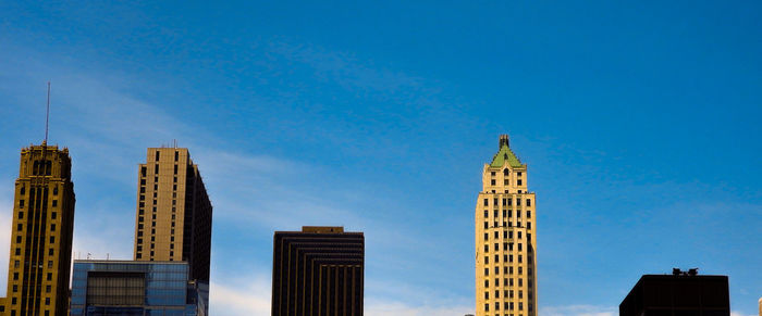 Low angle view of buildings against blue sky