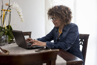 Woman using laptop at home