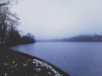 Scenic view of lake against sky during winter