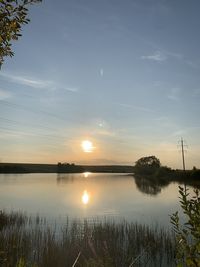 Scenic view of lake against sky during sunset