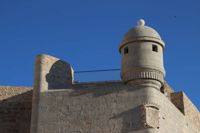 Low angle view of historic building against blue sky