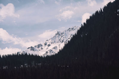 Scenic view of snow covered mountains against sky