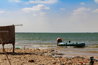 People on beach against sky