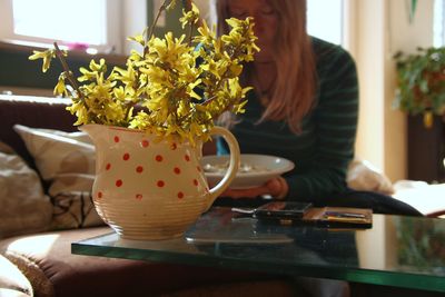 Woman sitting on table at home