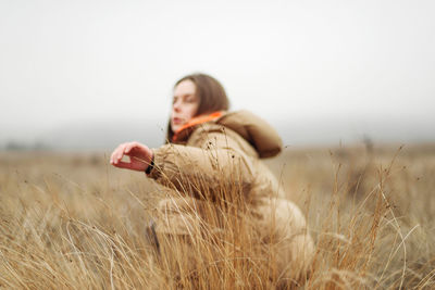 Unrecognizable female hands in autumn grass