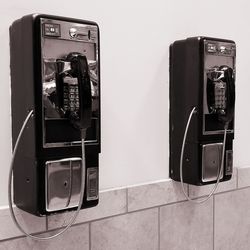 Close-up of telephone booth on wall