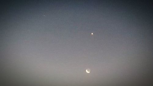 Low angle view of moon against sky at night