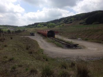 Scenic view of field against cloudy sky
