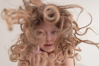 Low angle view of girl with messy hair