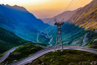 Low angle view of overhead cable car against sky