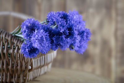 Bouquet of bright blue flowers. wicker basket with cornflower flowers.