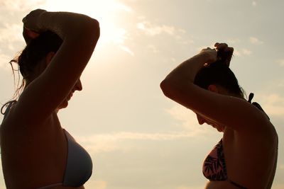 Portrait of young woman against sky during sunset