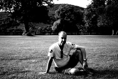 Portrait of man sitting on field