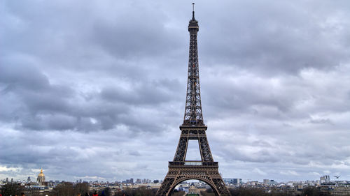 Tower of building against cloudy sky