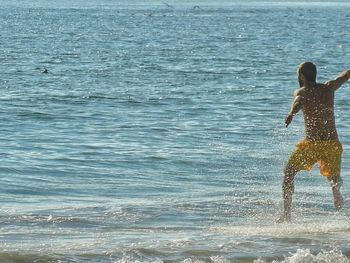 Woman jumping in sea