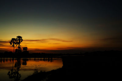 Scenic view of lake against orange sky