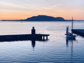 Silhouette pier on sea against sky during sunset