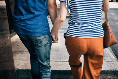 Rear view of friends standing outdoors