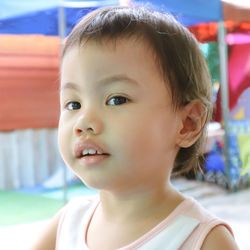 Close-up portrait of cute girl looking away