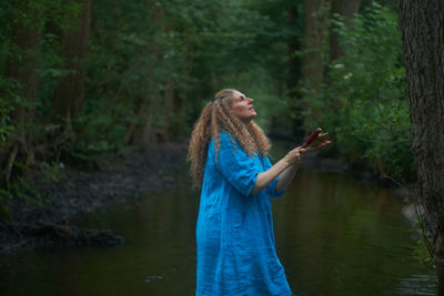 Woman standing in forest