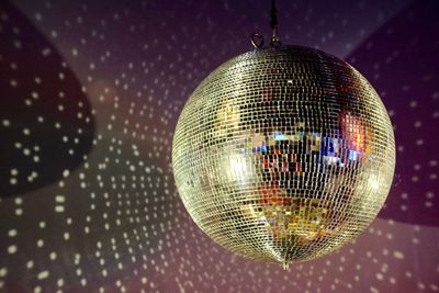 Close-up of disco ball hanging on ceiling