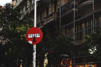 Road sign by street in city