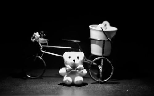 Close-up of toy on table against black background