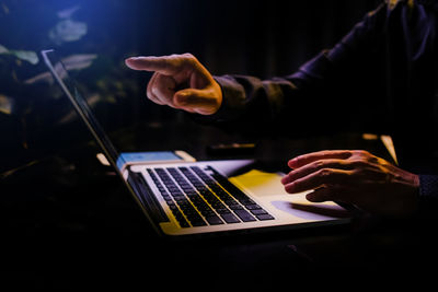 Midsection of man using laptop