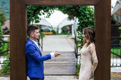 Side view of couple standing outdoors