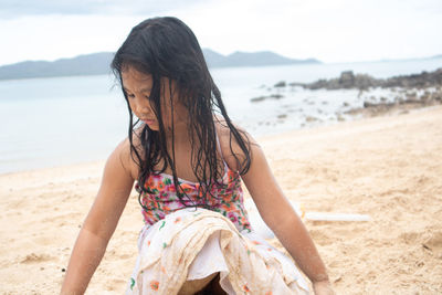 Midsection of woman at beach