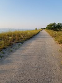 Empty road along countryside landscape