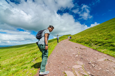 Man standing on field against sky